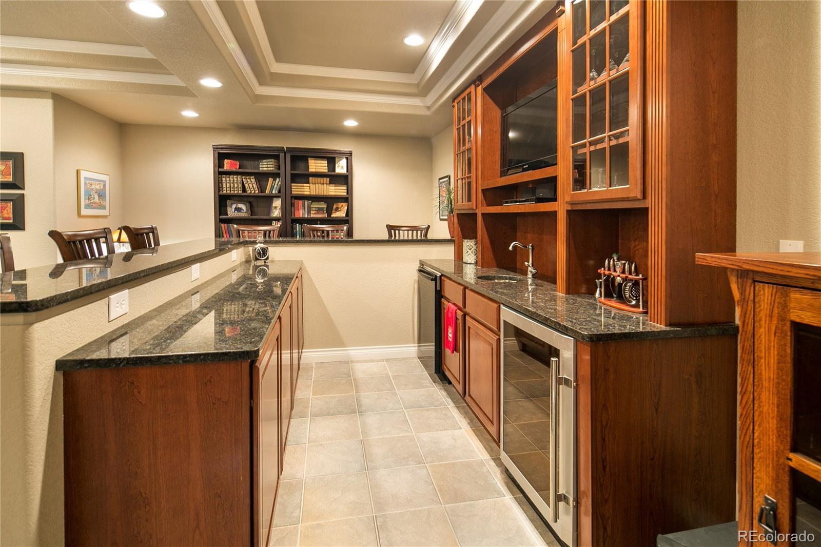 8397 Windhaven Drive Parker, CO 80134 - Photo 28 of 35 a kitchen with stainless steel appliances granite countertop a large stove a sink and a refrigerator