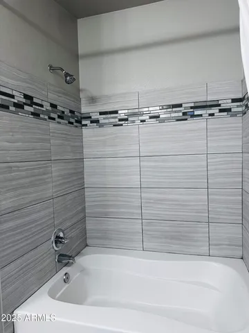 a bathroom with a shower and a bathtub