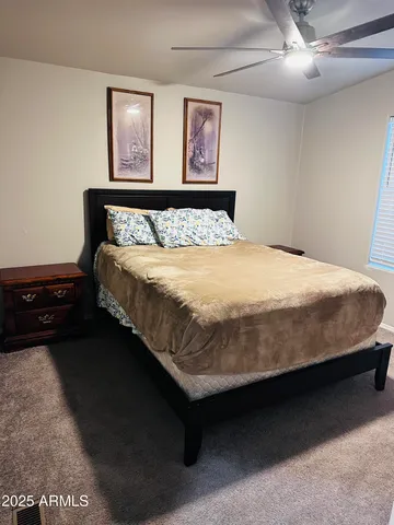 a large bed sitting in a bedroom next to a lamp