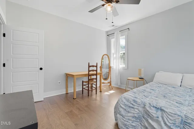a view of a swimming pool with a big yard and large trees