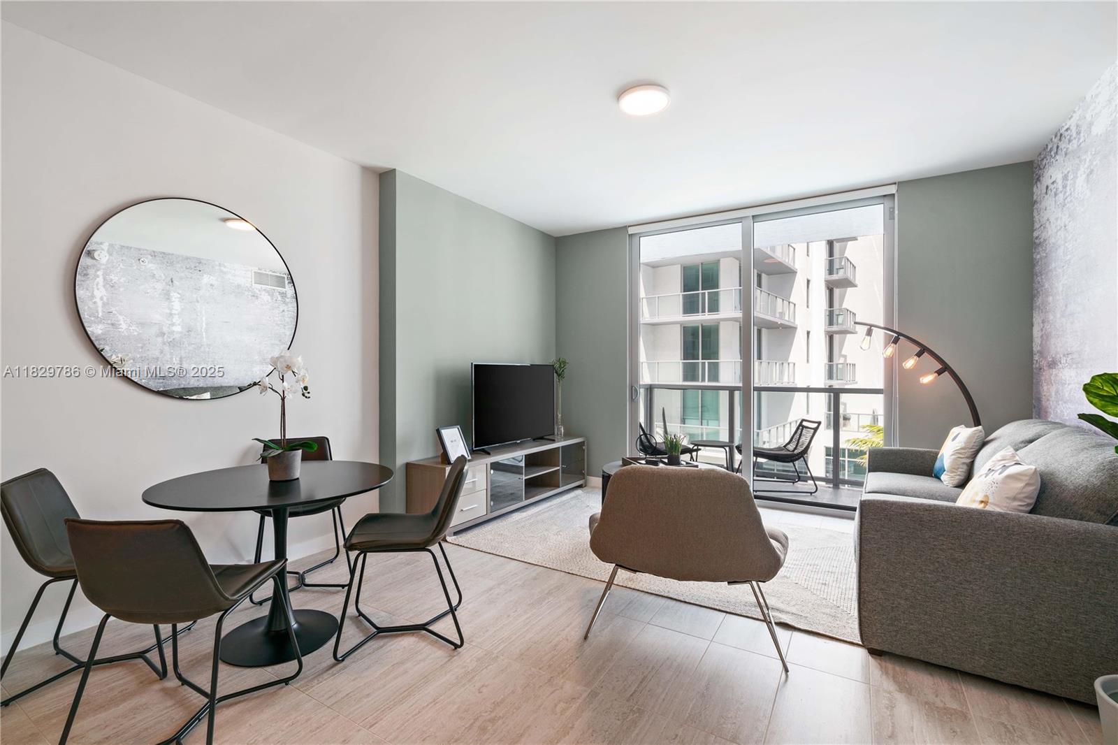 3900 Biscayne Boulevard, Unit S818 Miami, FL 33137 - Photo 2 of 32 a living room with furniture a table and a large window