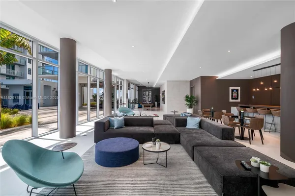 a living room filled with furniture and a potted plant