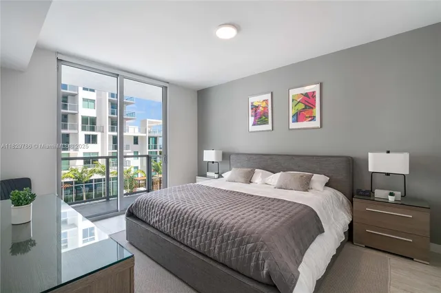 a bedroom with a balcony a bed and a large window