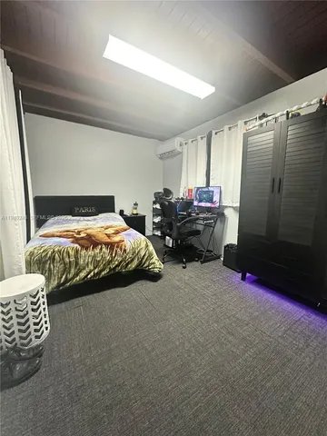 a spacious bathroom with a granite countertop toilet a sink and mirror