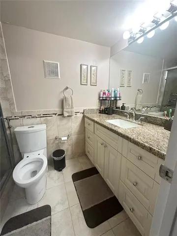 a spacious bedroom with a bed and a walk in closet