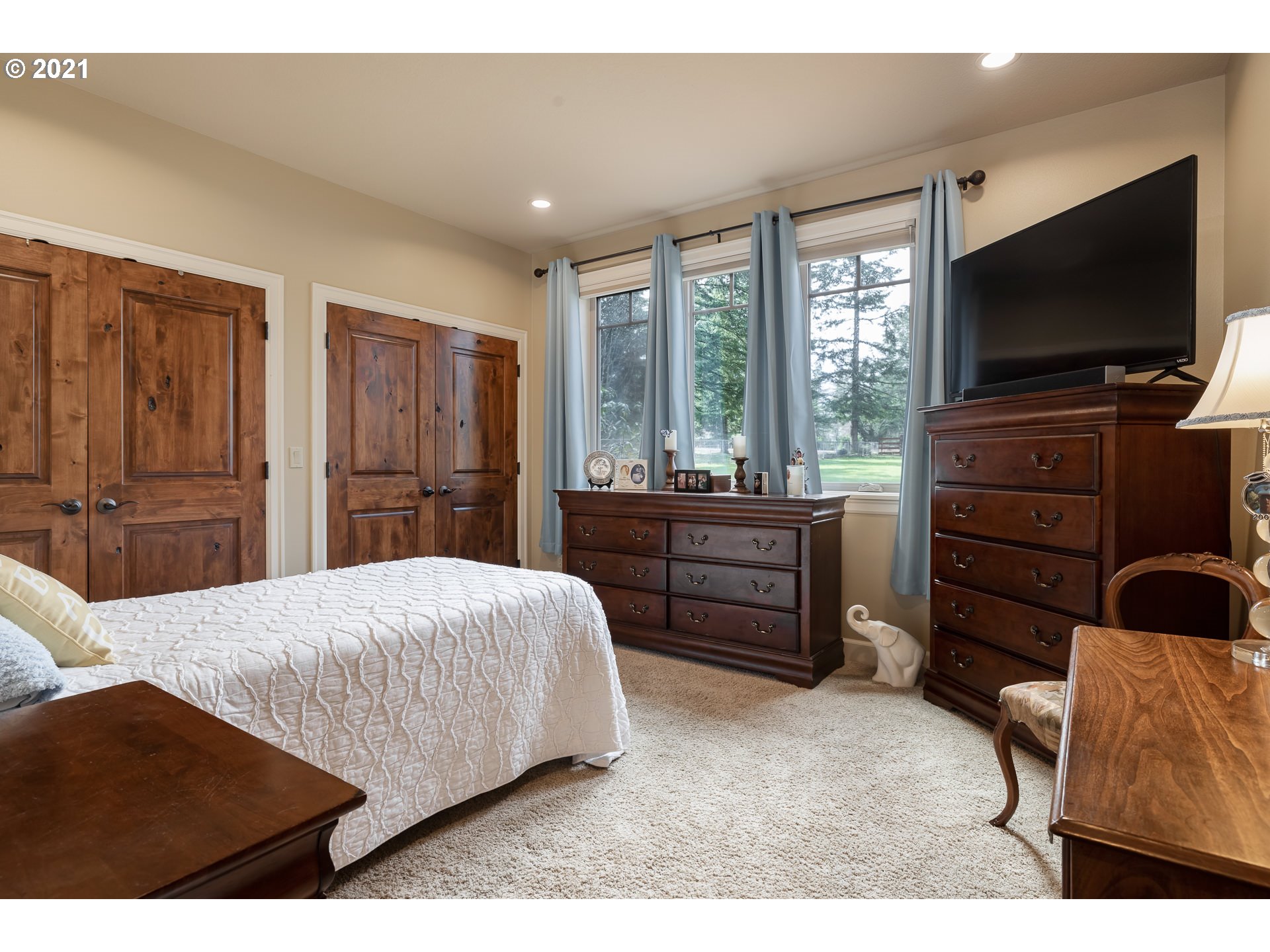 20484 South Springwater Road Estacada, OR 97023 - Photo 19 of 32 a bedroom with a bed and a flat screen tv