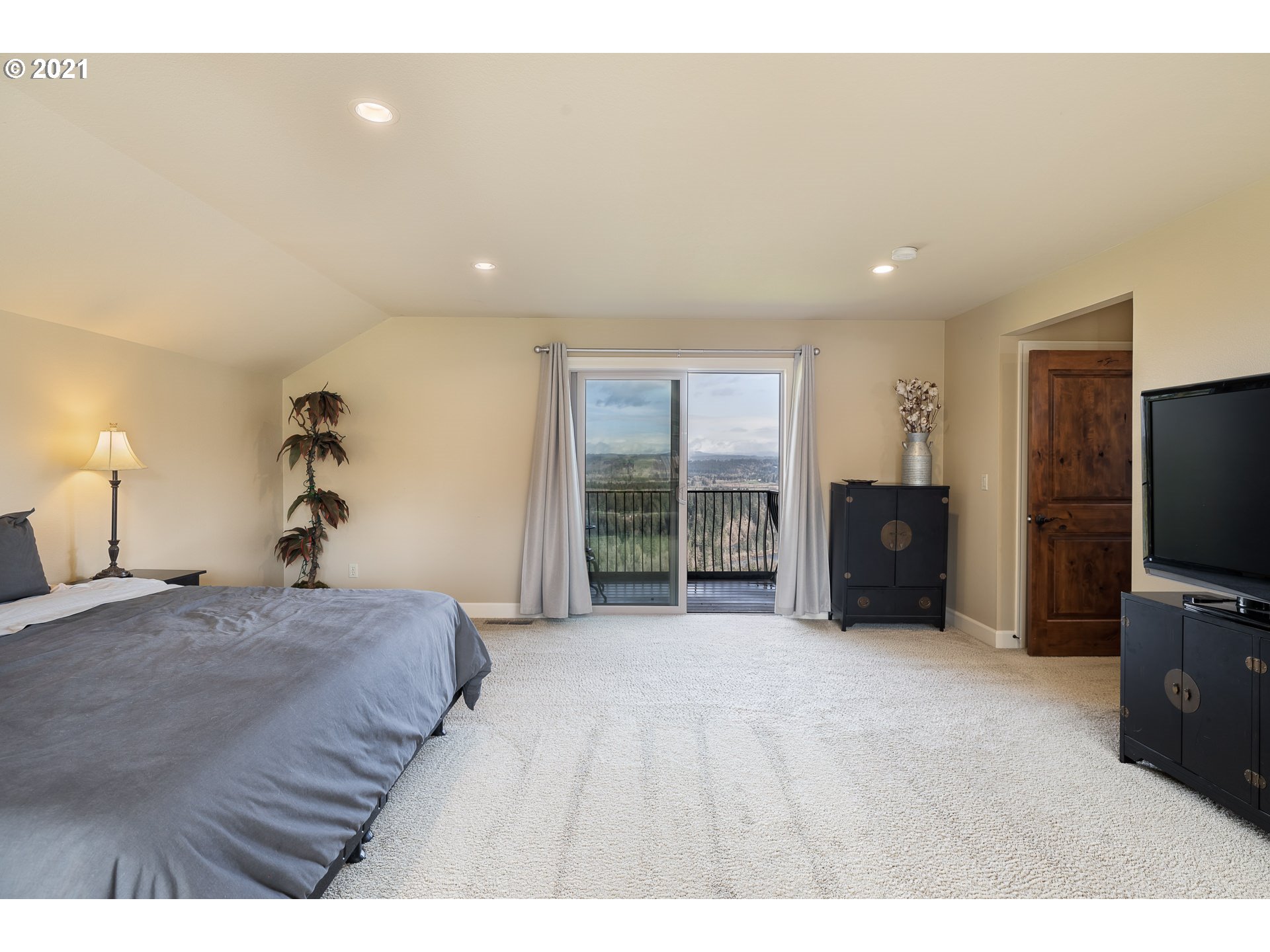 20484 South Springwater Road Estacada, OR 97023 - Photo 24 of 32 a spacious bedroom with a bed and a flat screen tv
