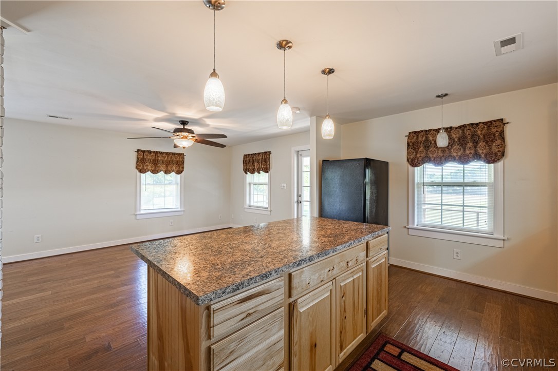 60 Rodeo Lane Dillwyn, VA 23936 - Photo 12 of 45 a kitchen with kitchen island granite countertop a sink a center island and wooden floor