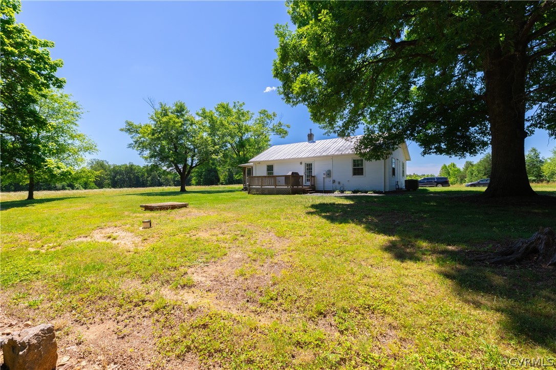 60 Rodeo Lane Dillwyn, VA 23936 - Photo 31 of 45 a view of a swimming pool with lawn chairs and large trees