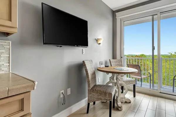 a view of a livingroom with furniture and a flat screen tv