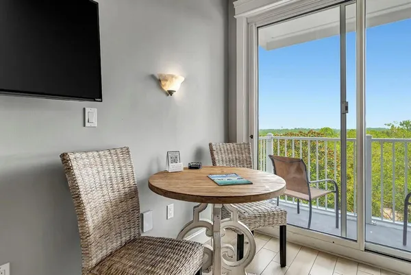 a view of a dining room with furniture wooden floor and a flat screen tv
