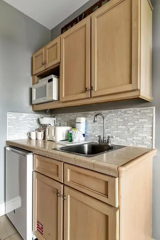 a kitchen with stainless steel appliances granite countertop a sink and cabinets