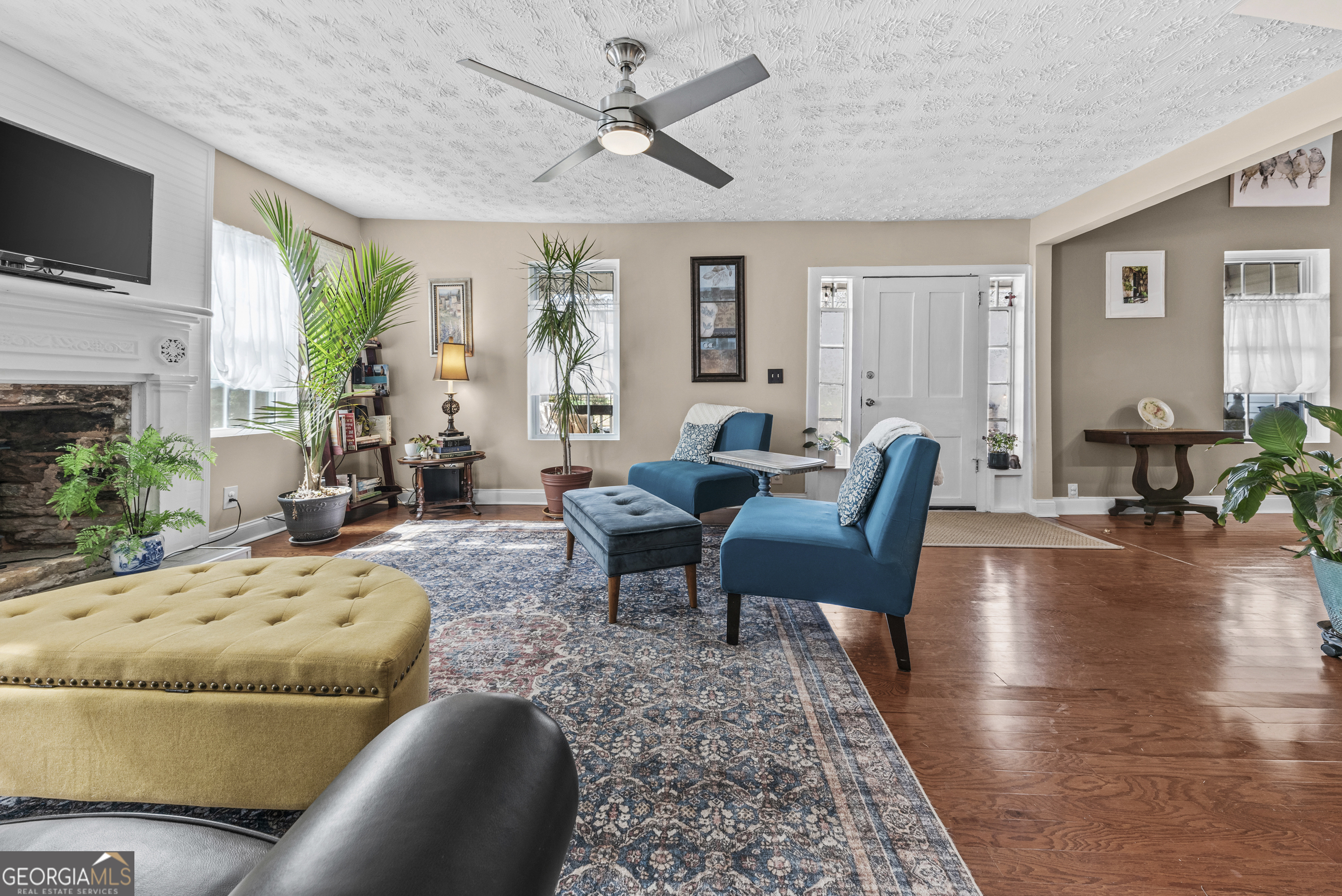 178 Fairplay Street Rutledge, GA 30663 - Photo 21 of 54 a living room with furniture fireplace and a flat screen tv
