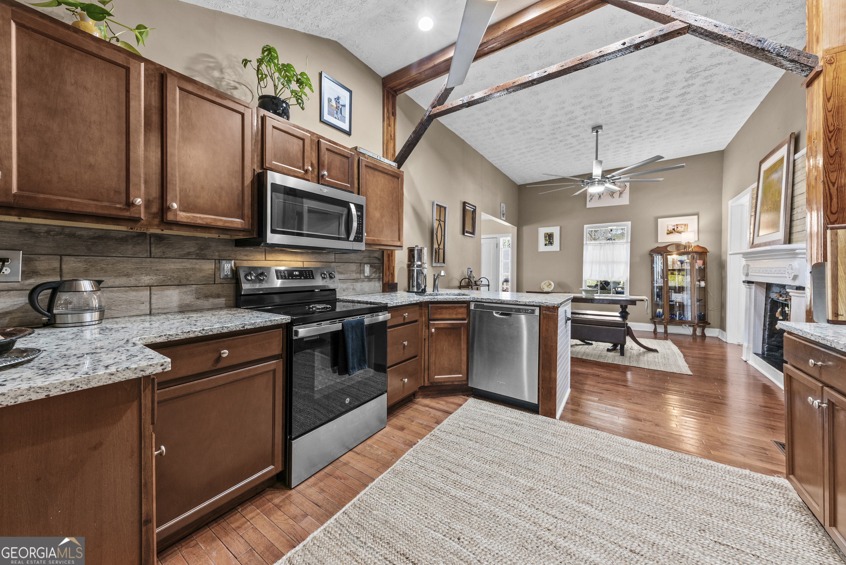 178 Fairplay Street Rutledge, GA 30663 - Photo 25 of 54 a kitchen with stainless steel appliances granite countertop wooden cabinets a stove top oven a sink and dishwasher