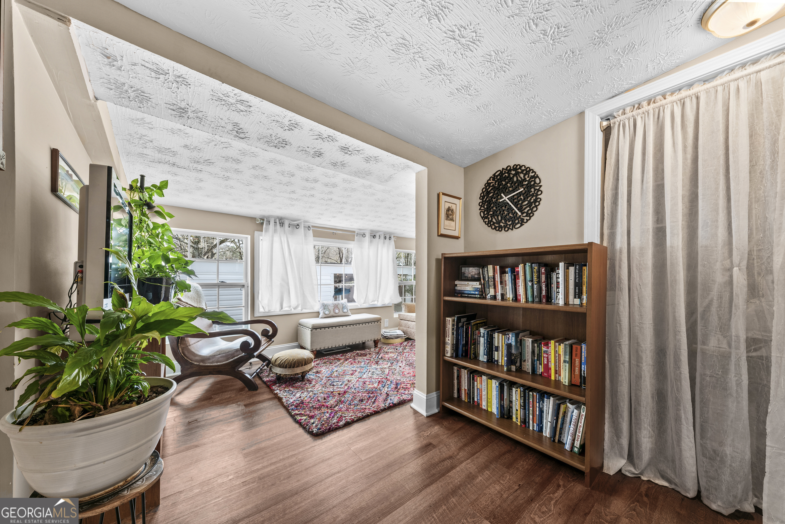178 Fairplay Street Rutledge, GA 30663 - Photo 34 of 54 a living room with furniture and a book shelf