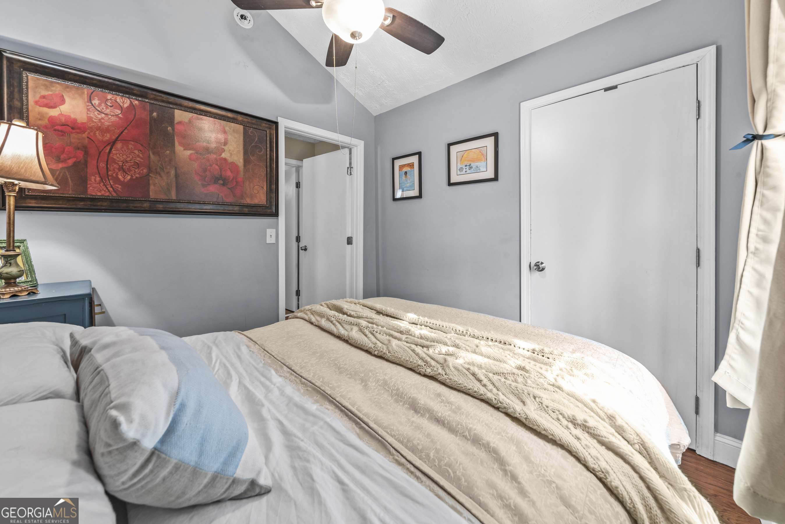 178 Fairplay Street Rutledge, GA 30663 - Photo 46 of 54 a bedroom with a large bed and a chandelier