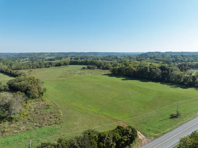 a view of a field with an ocean