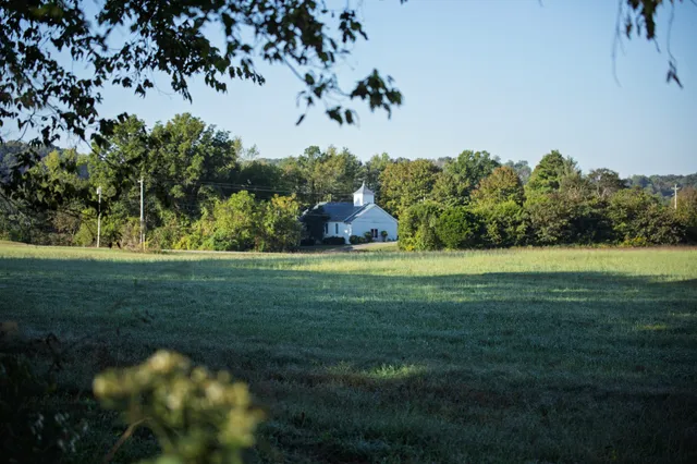 a view of a house with a yard porch and sitting area