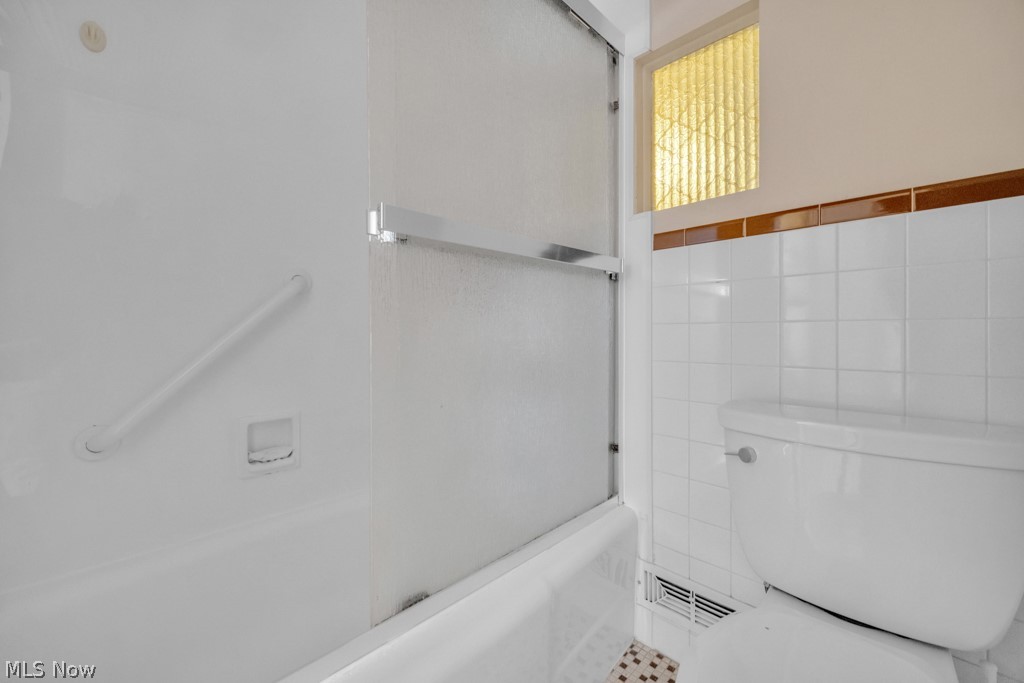 6846 Revere Road Cleveland, OH 44130 - Photo 19 of 30 Full bathroom featuring enclosed tub / shower combo and tile walls