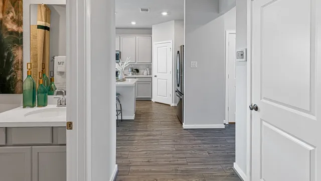 a bathroom with a sink a toilet a mirror and bathtub