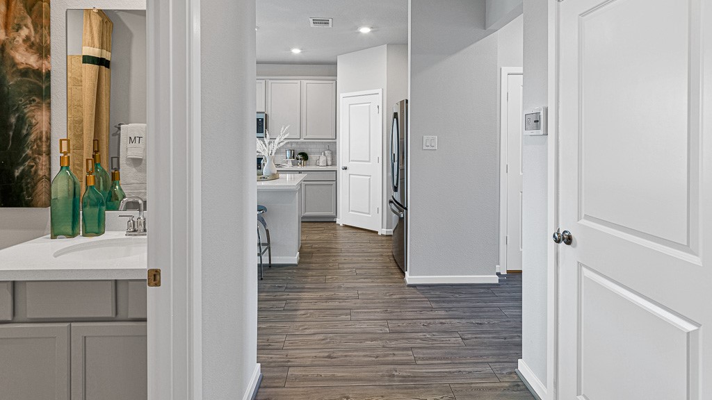 1202 Buffalo Run Tomball, TX 77375 - Photo 9 of 45 a view of a hallway with wooden floor and staircase