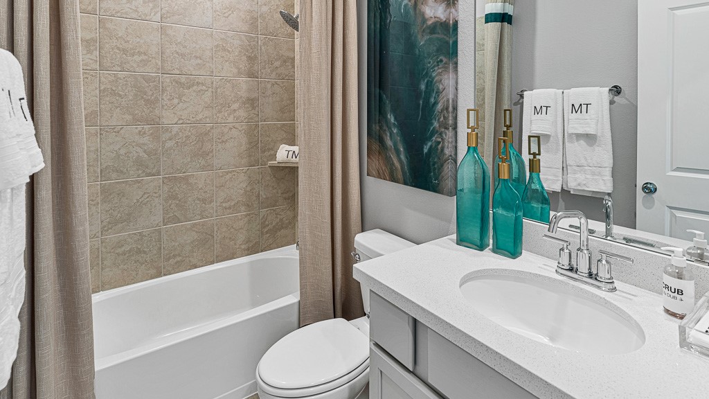 1202 Buffalo Run Tomball, TX 77375 - Photo 10 of 45 a bathroom with a sink a toilet a mirror and bathtub