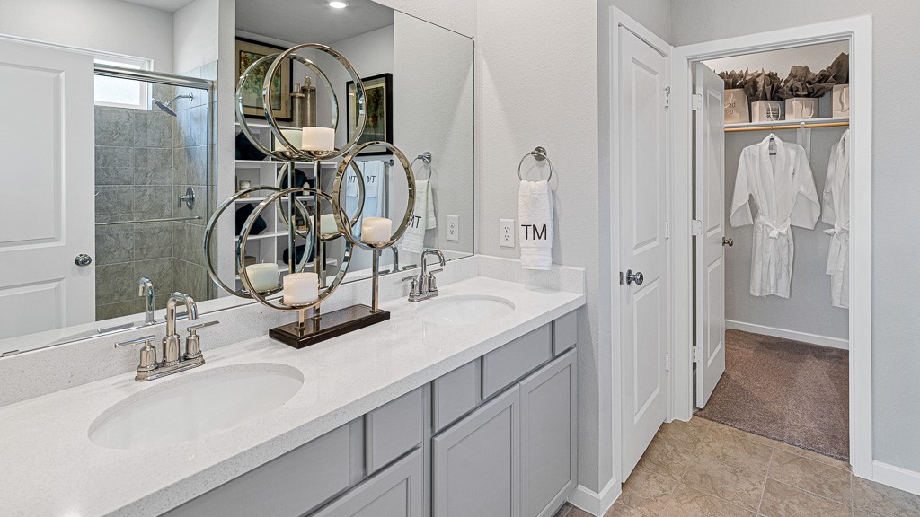 1202 Buffalo Run Tomball, TX 77375 - Photo 24 of 45 a bathroom with a double vanity sink a mirror and shower
