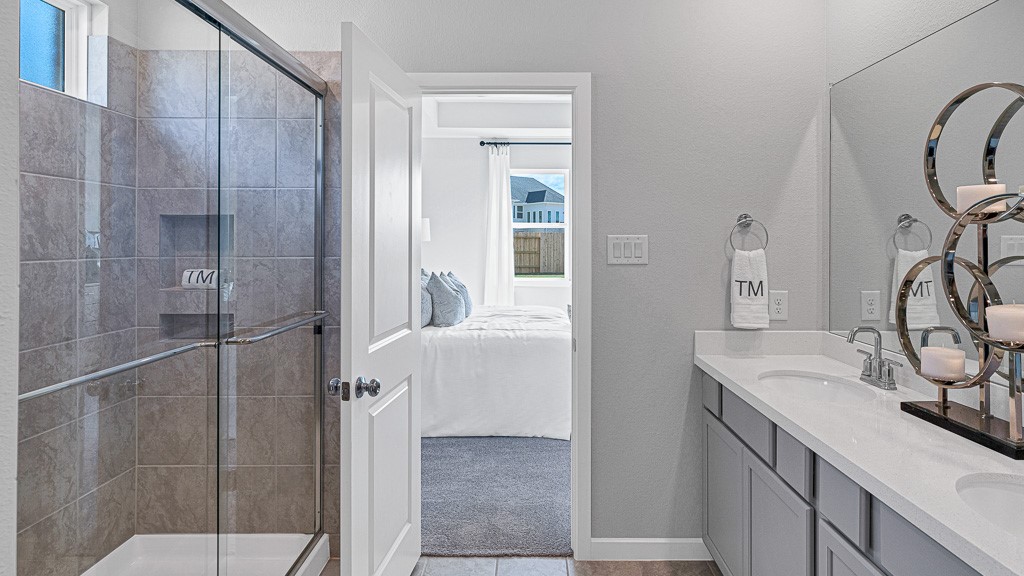 1202 Buffalo Run Tomball, TX 77375 - Photo 27 of 45 a bathroom with a sink vanity and a mirror