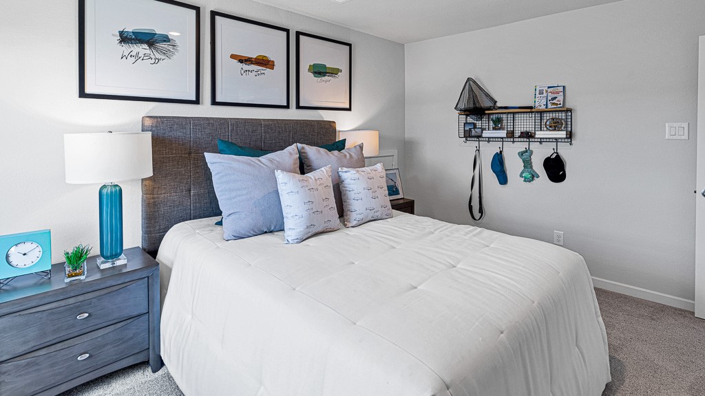 1202 Buffalo Run Tomball, TX 77375 - Photo 35 of 45 a bedroom with a bed and a painting on the wall