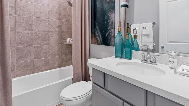 a bedroom with a bed and painting on the wall