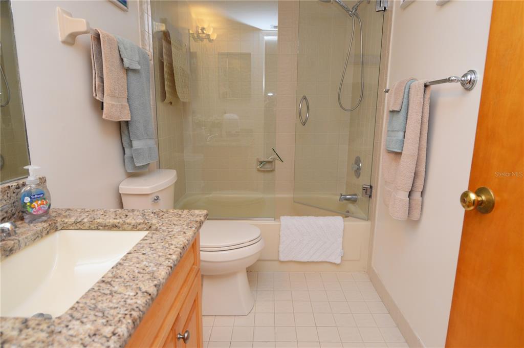 900 Gulf Boulevard, Unit 907 Indian Rocks Beach, FL 33785 - Photo 55 of 88 a bathroom with a granite countertop sink toilet and shower