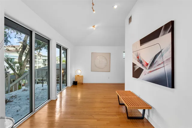 a living room with furniture and a painting on the wall