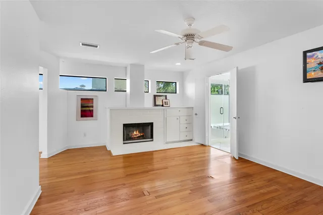 a view of livingroom with fireplace wooden floor and window