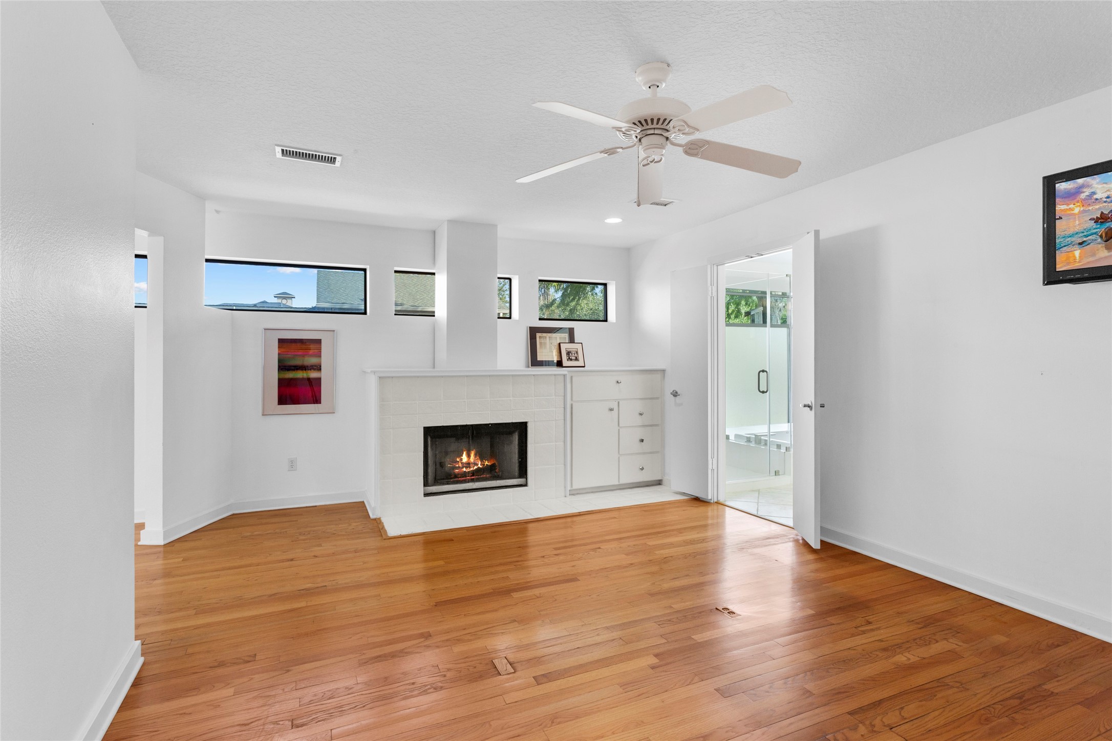 67 Harbor Lane Kemah, TX 77565 - Photo 15 of 47 a view of livingroom with fireplace wooden floor and window