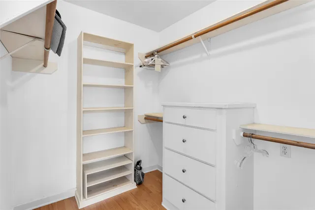 a view of walk in closet with empty racks