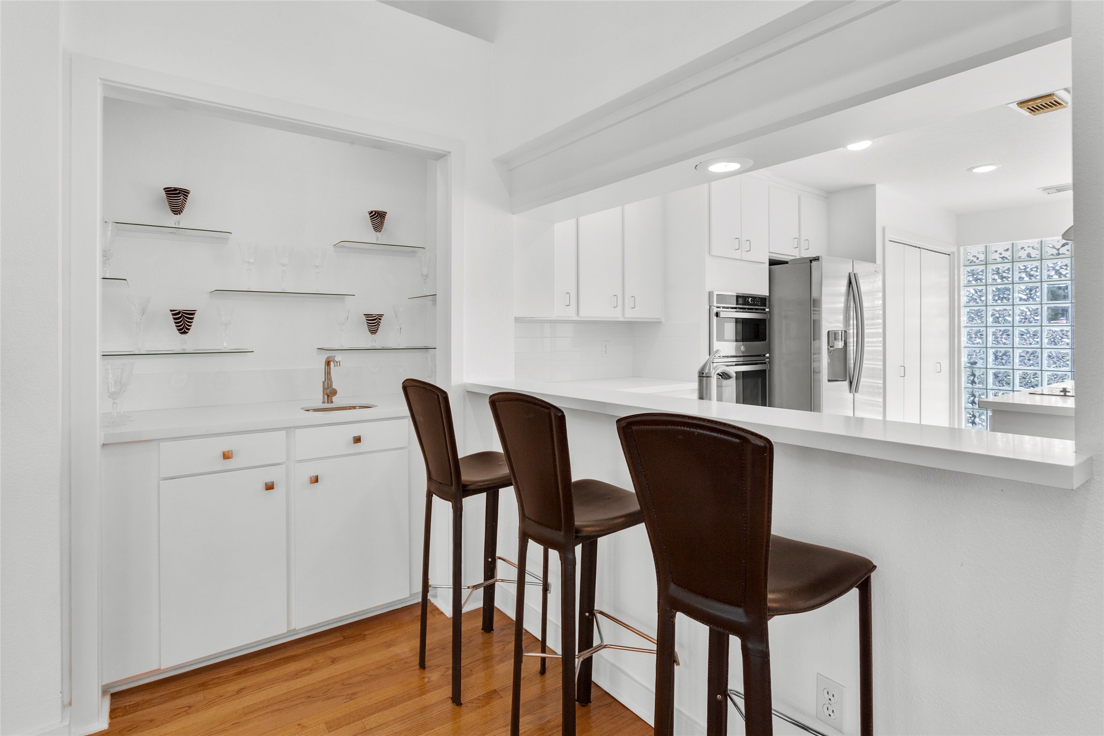 67 Harbor Lane Kemah, TX 77565 - Photo 9 of 47 a kitchen with stainless steel appliances granite countertop a table chairs and a refrigerator