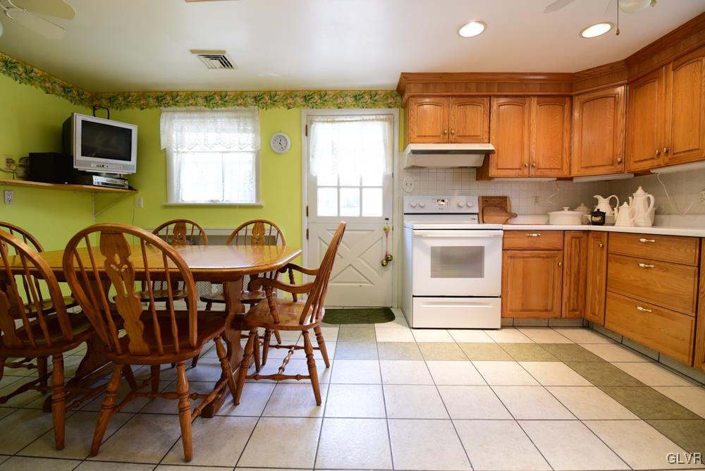 1177 Beaver Valley Road Stroudsburg, PA 18360 - Photo 23 of 46 a kitchen with stainless steel appliances granite countertop a stove top oven a sink a dining table and chairs