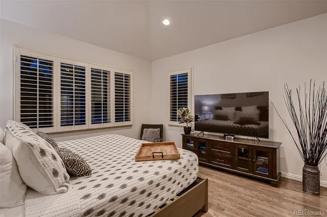 a living room with stainless steel appliances kitchen island furniture and a flat screen tv