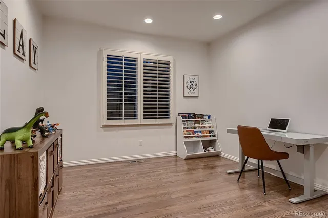 a living room with couch and a potted plant