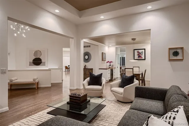 a living room with furniture and a floor to ceiling window