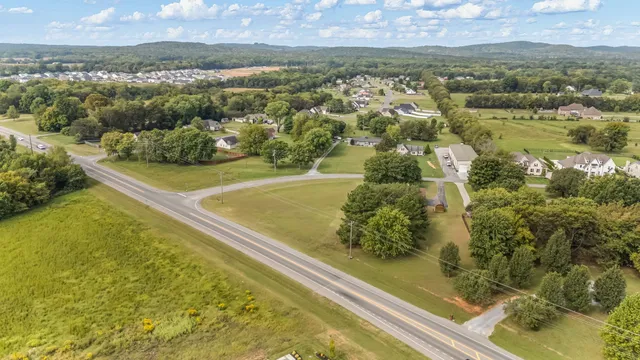 an aerial view of a residential houses with outdoor space