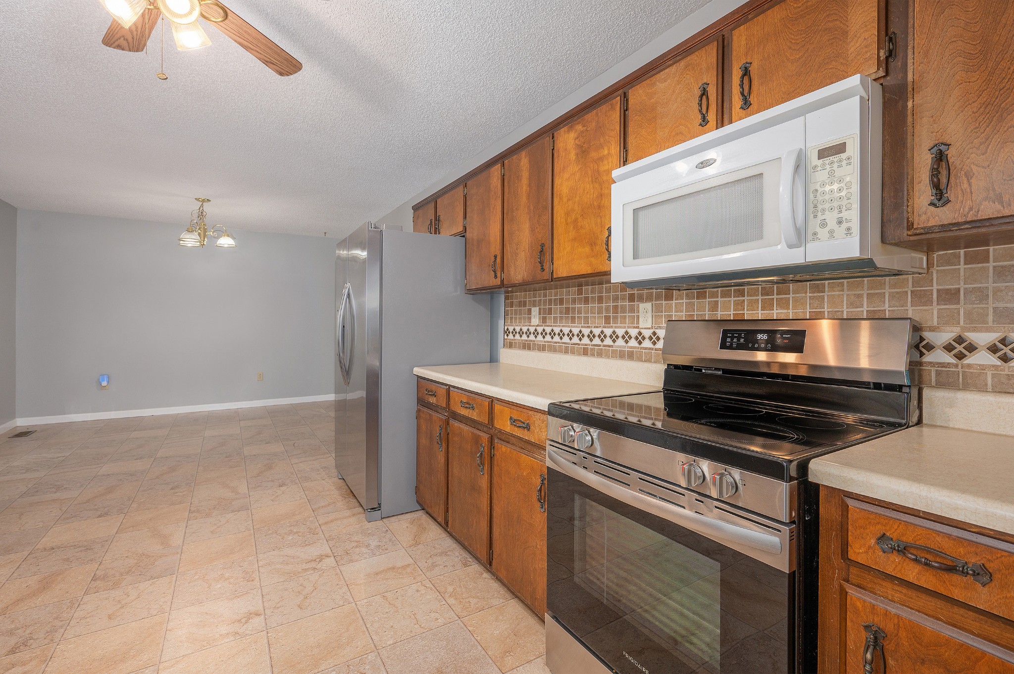 5665 Old Salem Road Rockvale, TN 37153 - Photo 32 of 41 a kitchen with stainless steel appliances granite countertop a stove a sink and a microwave