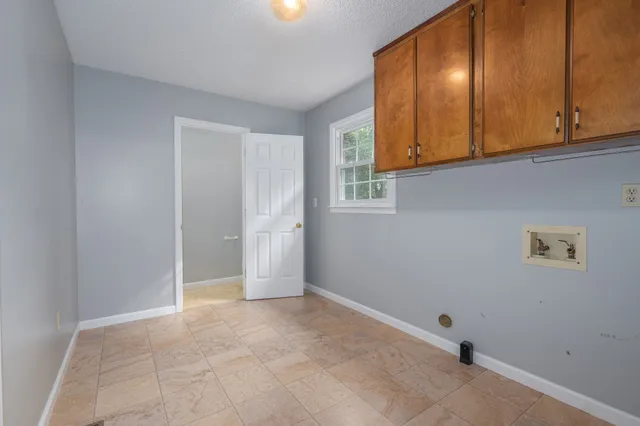 an empty room with ceiling fan and window