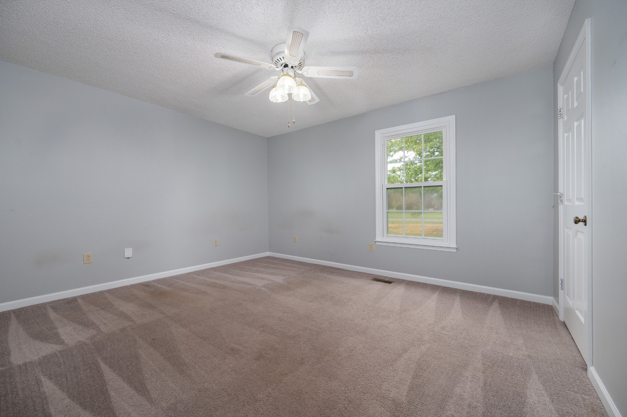 5665 Old Salem Road Rockvale, TN 37153 - Photo 36 of 41 an empty room with a chandelier fan and windows