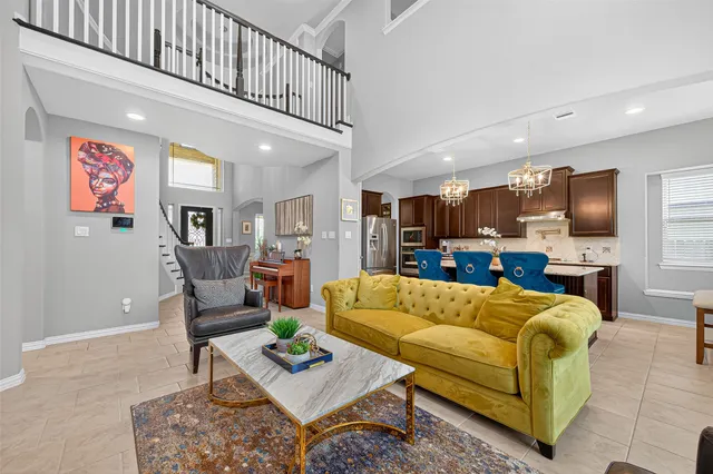 a living room with furniture kitchen view and a flat screen tv