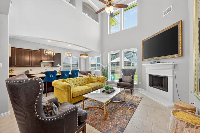 a living room with furniture a flat screen tv and a fireplace