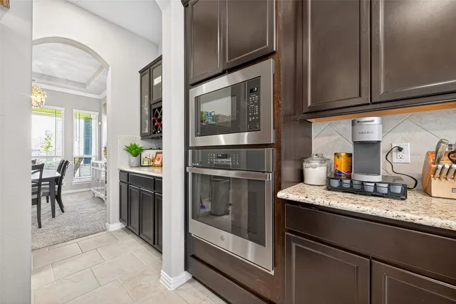 a kitchen with granite countertop stainless steel appliances and wooden cabinets