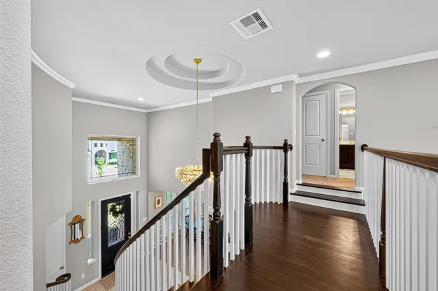 a view of entryway with wooden floor and windows