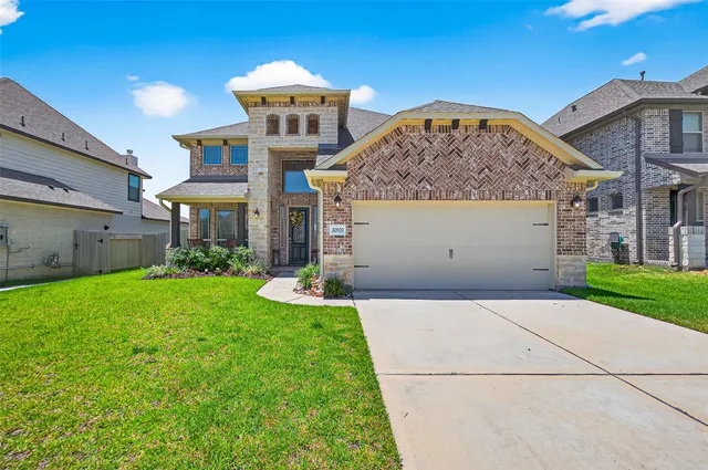 a front view of a house with a yard and garage