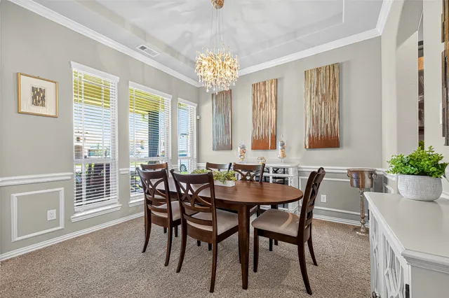 a view of a dining room with furniture and window
